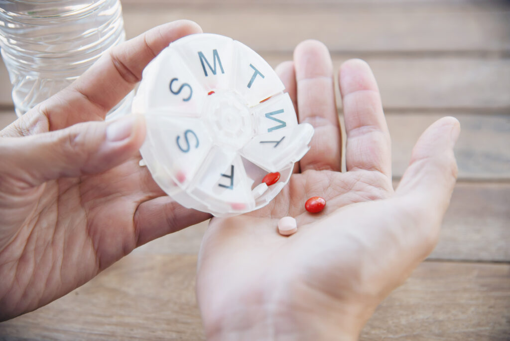 Using pill organizer and medication tracker for medication adherence